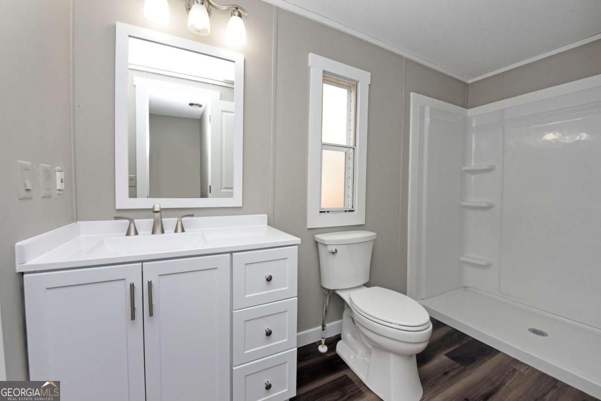 273 Rose Ray Road Ellijay, GA 30540 - Photo 31 of 32 a bathroom with a sink toilet and shower