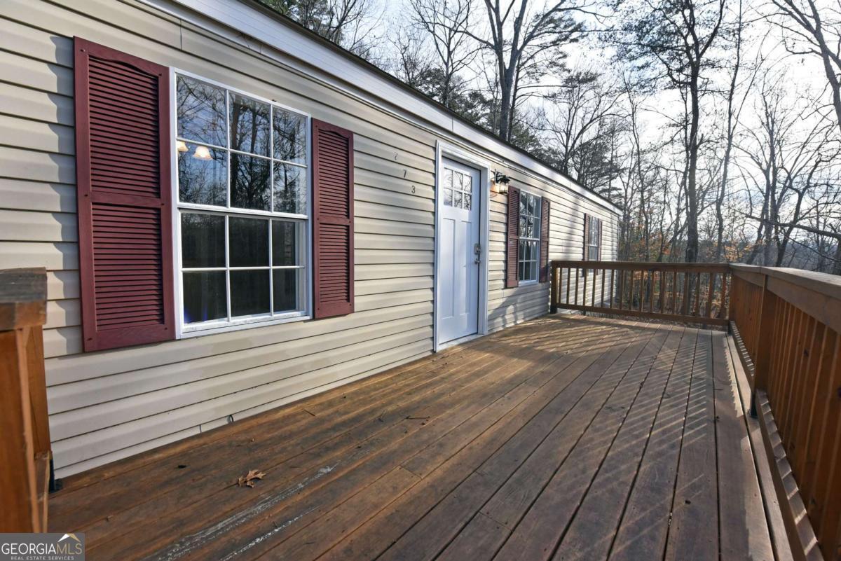 273 Rose Ray Road Ellijay, GA 30540 - Photo 10 of 32 a view of a house with a wooden deck