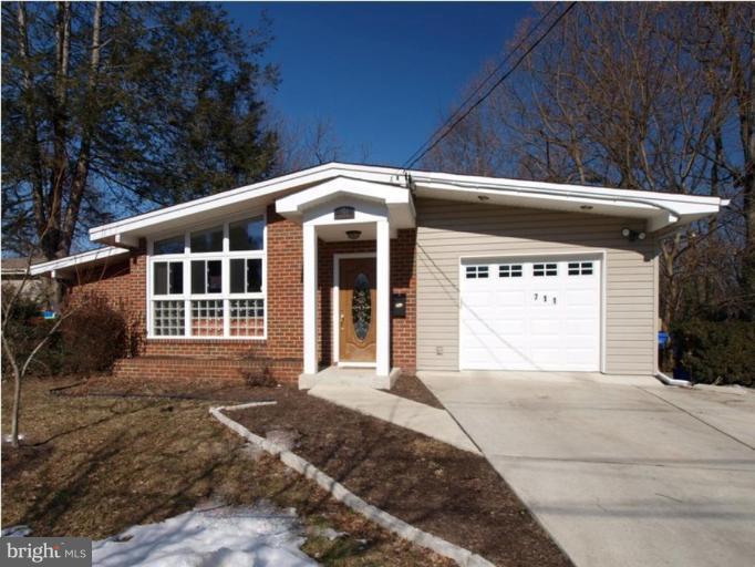 711 North Belgrade Road Silver Spring, MD 20902 - Photo 11 of 25 a front view of a house with a yard and garage