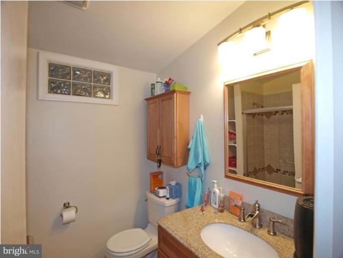 711 North Belgrade Road Silver Spring, MD 20902 - Photo 22 of 25 a bathroom with a toilet sink and mirror