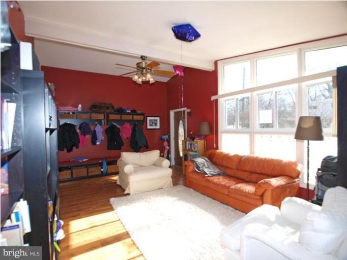 711 North Belgrade Road Silver Spring, MD 20902 - Photo 10 of 25 a living room with furniture and a floor to ceiling window