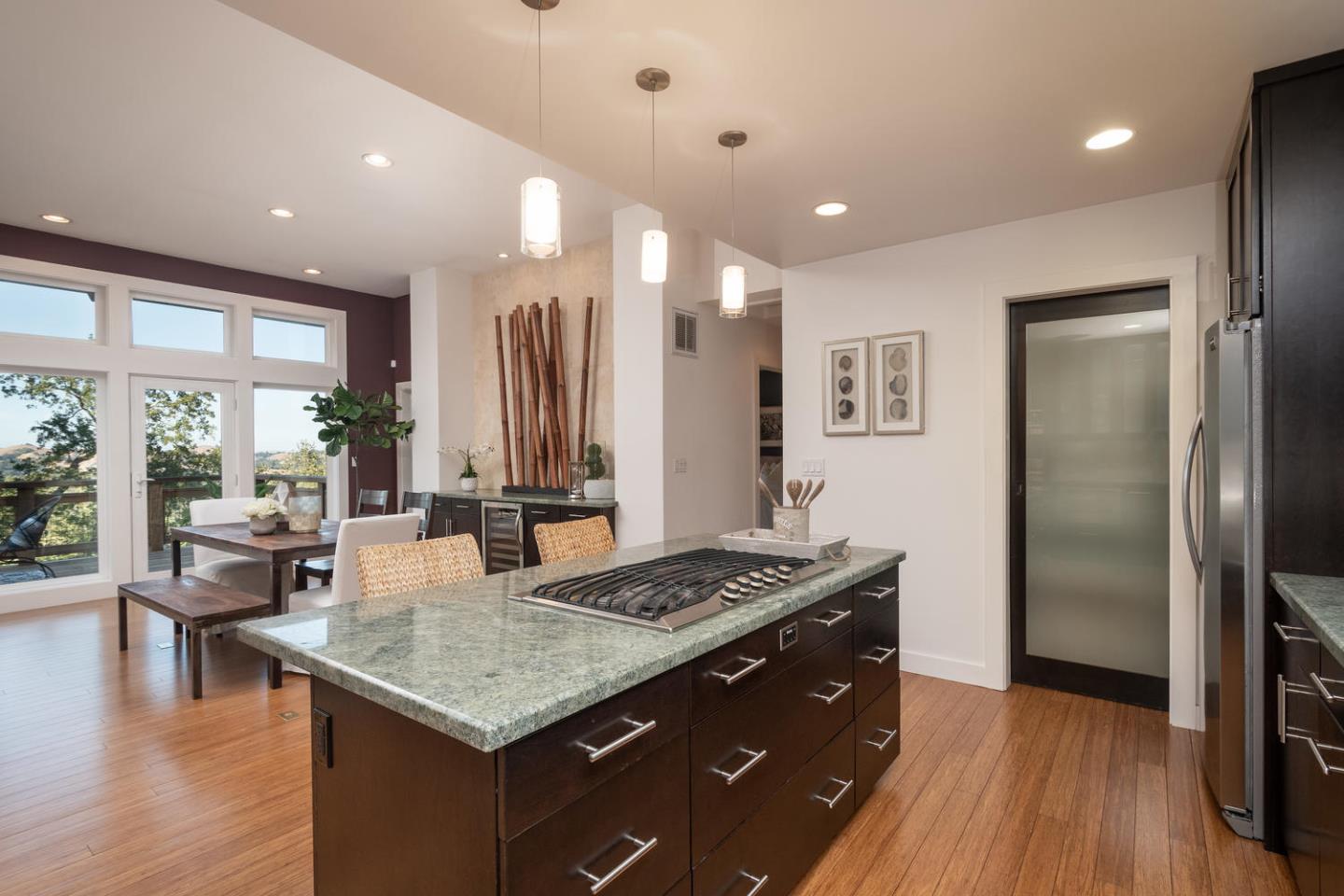 672 Moraga Road Lafayette, CA 94549 - Photo 17 of 43 a kitchen with stainless steel appliances granite countertop a refrigerator a stove and a wooden floors