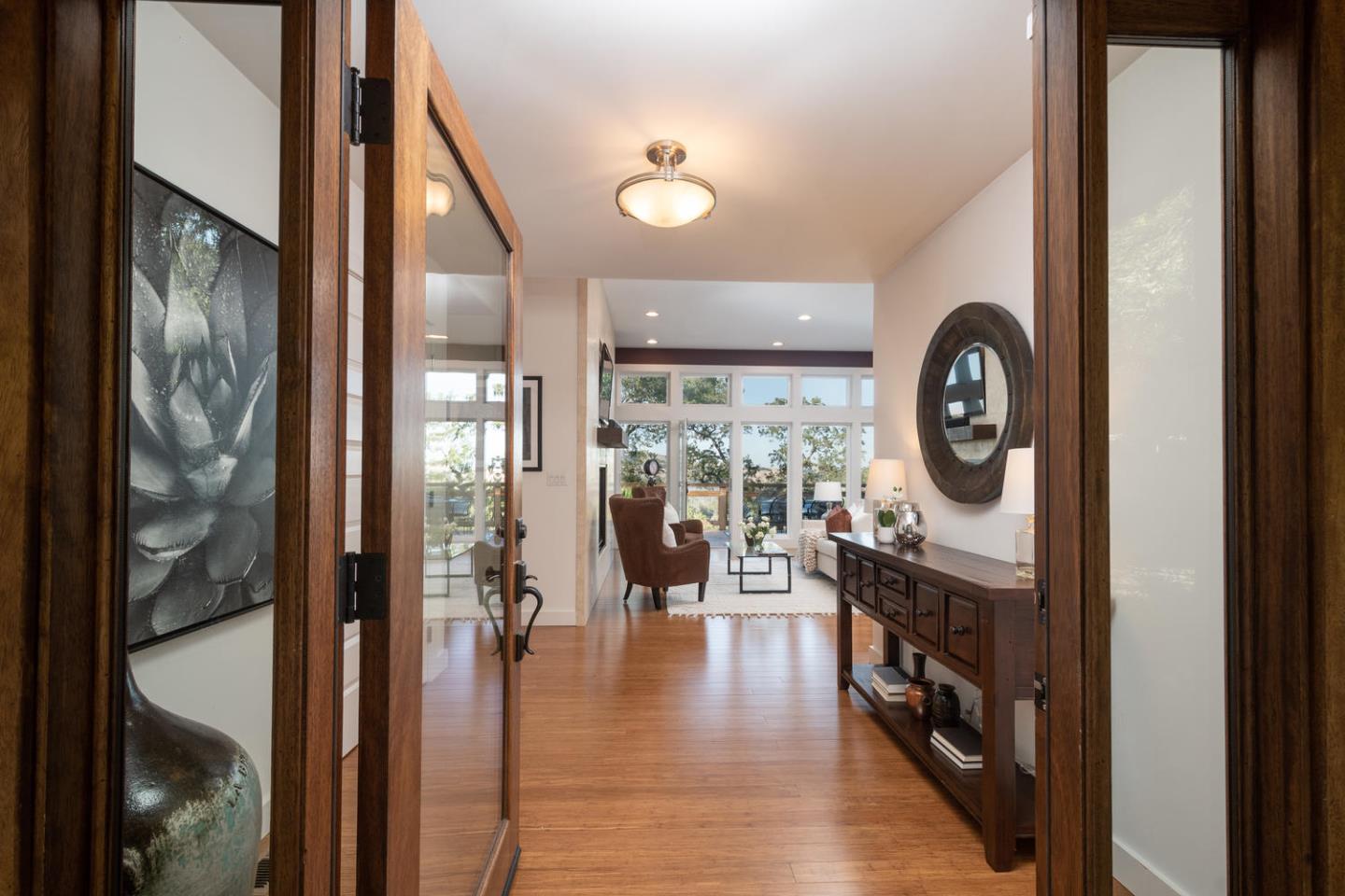 672 Moraga Road Lafayette, CA 94549 - Photo 8 of 43 a view of a hallway with wooden floor windows and a kitchen view