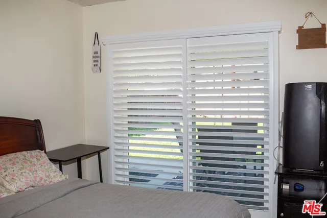 a view of room with a window and a television