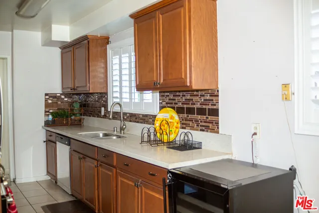 a kitchen with a sink cabinets and window