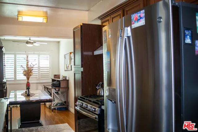 a kitchen with stainless steel appliances a refrigerator and a stove