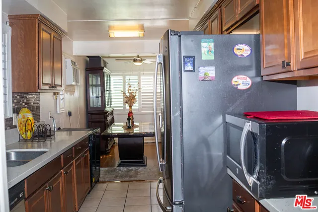 a kitchen with stainless steel appliances granite countertop a refrigerator and a stove