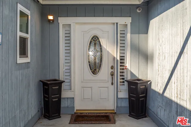 a front view of a house with entryway and wooden floor