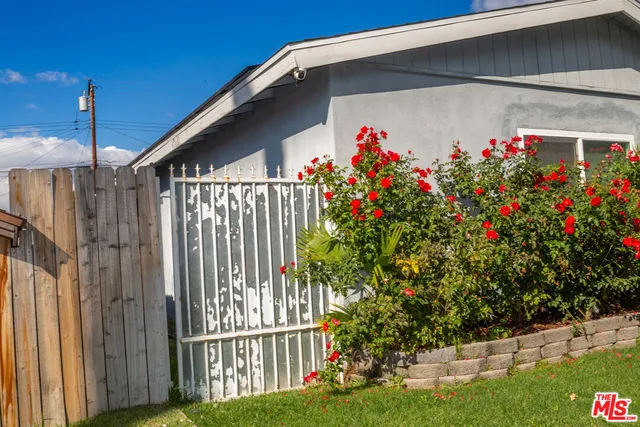 a view of a house with a flower garden