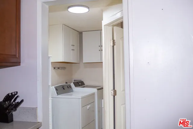a view of storage and utility room with washer and dryer