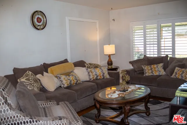 a living room with furniture a rug and a large window