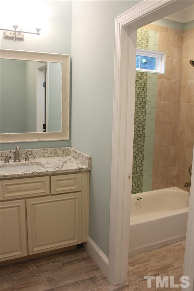 741 Shelley Road Raleigh, NC 27609 - Photo 14 of 25 a bathroom with a granite countertop sink and a mirror