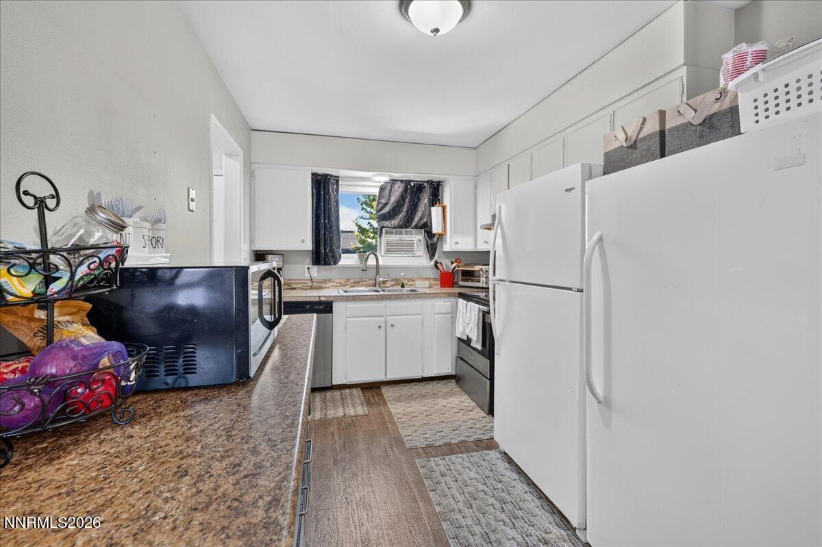 5 Smithridge Park Reno, NV 89502 - Photo 7 of 24 a kitchen with stainless steel appliances a refrigerator sink and white cabinets