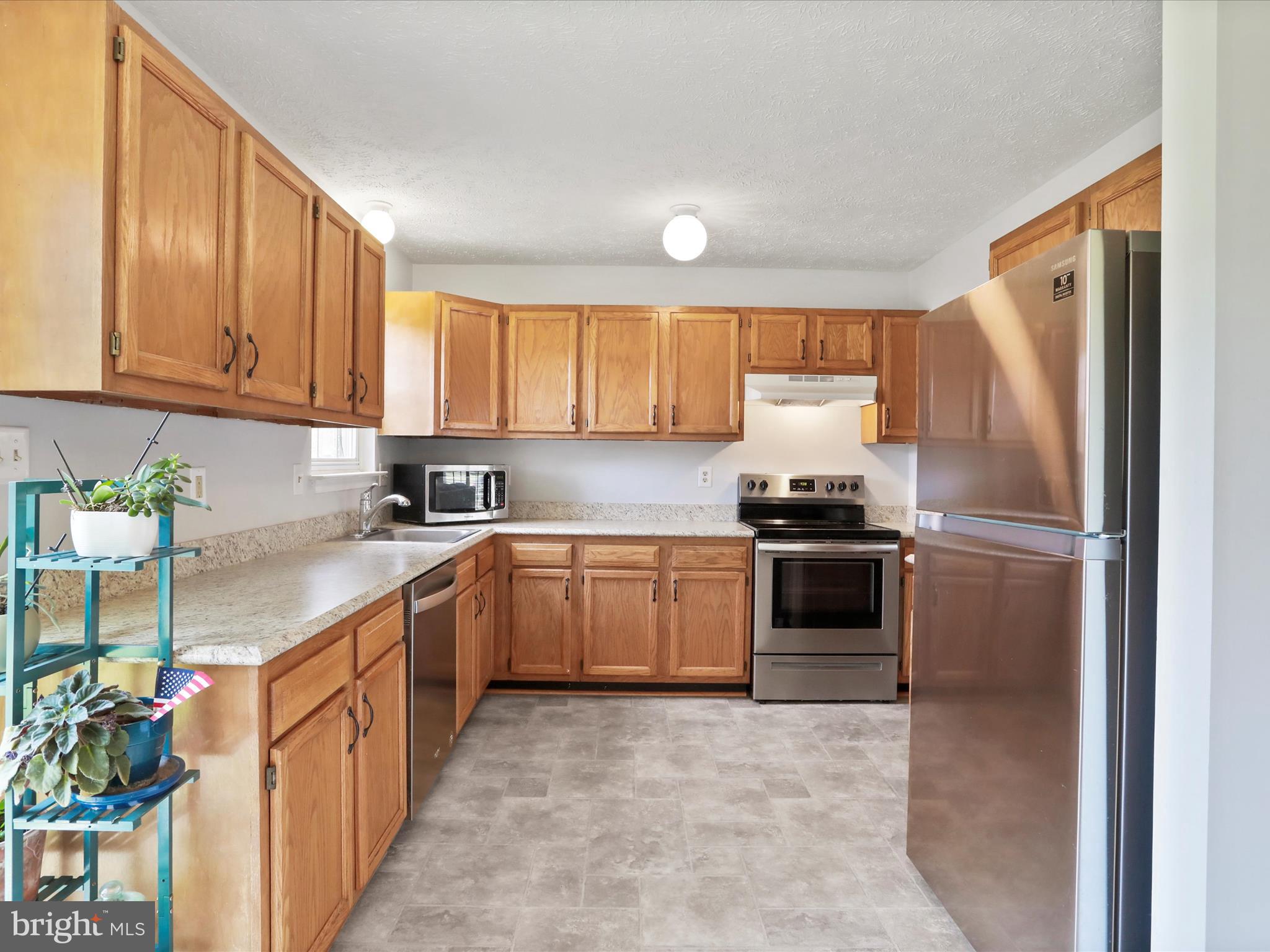 100 Lloyds Road Winchester, VA 22602 - Photo 11 of 39 a kitchen with granite countertop a refrigerator sink and cabinets