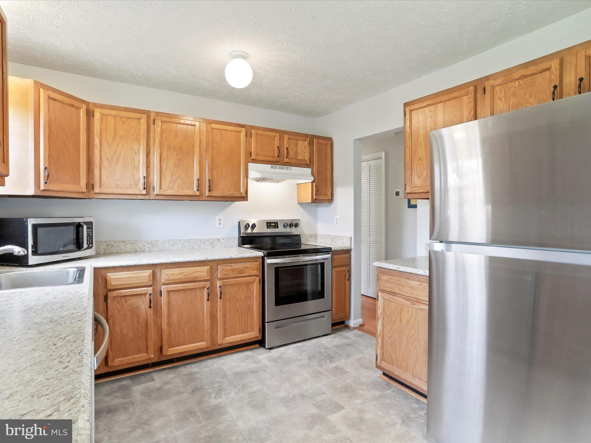 100 Lloyds Road Winchester, VA 22602 - Photo 12 of 39 a kitchen with stainless steel appliances granite countertop a refrigerator and a sink