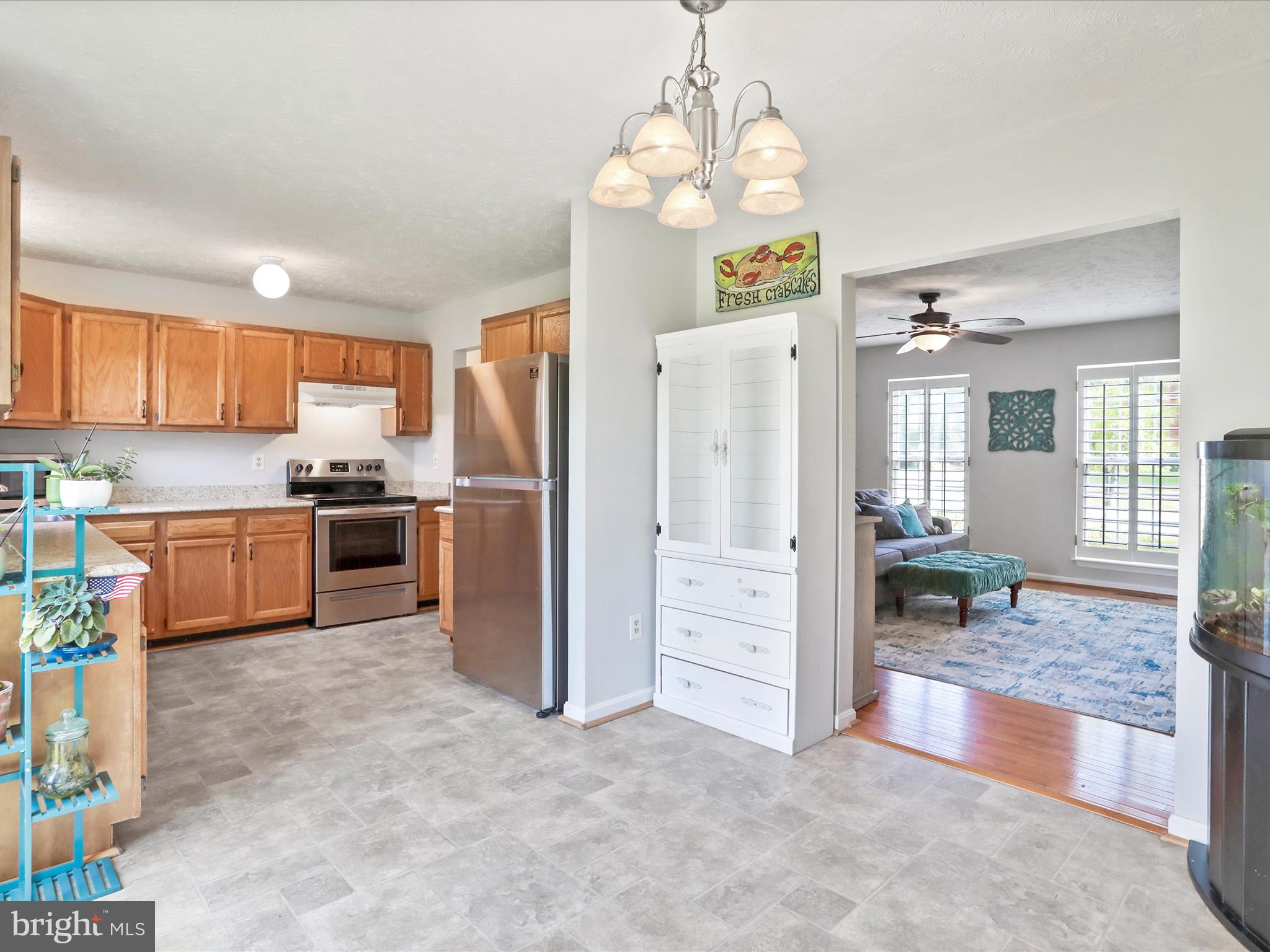 100 Lloyds Road Winchester, VA 22602 - Photo 13 of 39 a kitchen with stainless steel appliances granite countertop a refrigerator and a stove top oven
