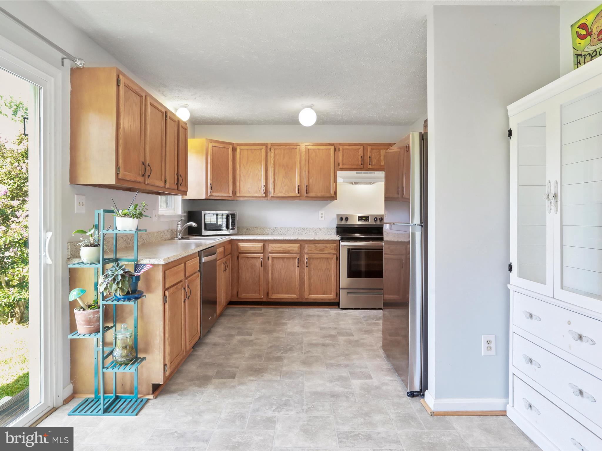 100 Lloyds Road Winchester, VA 22602 - Photo 14 of 39 a kitchen with stainless steel appliances granite countertop a stove a sink and a refrigerator