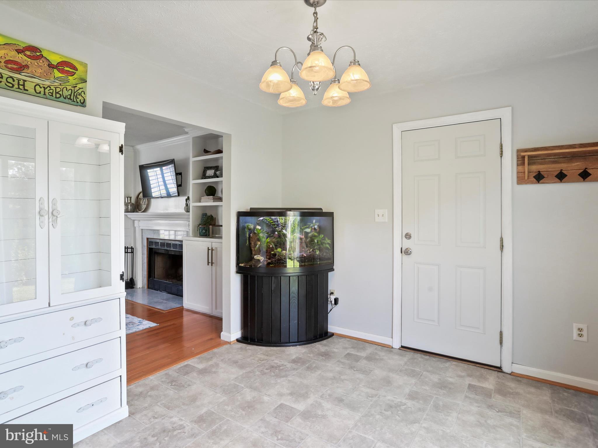 100 Lloyds Road Winchester, VA 22602 - Photo 16 of 39 an entryway with a chandelier and a fireplace