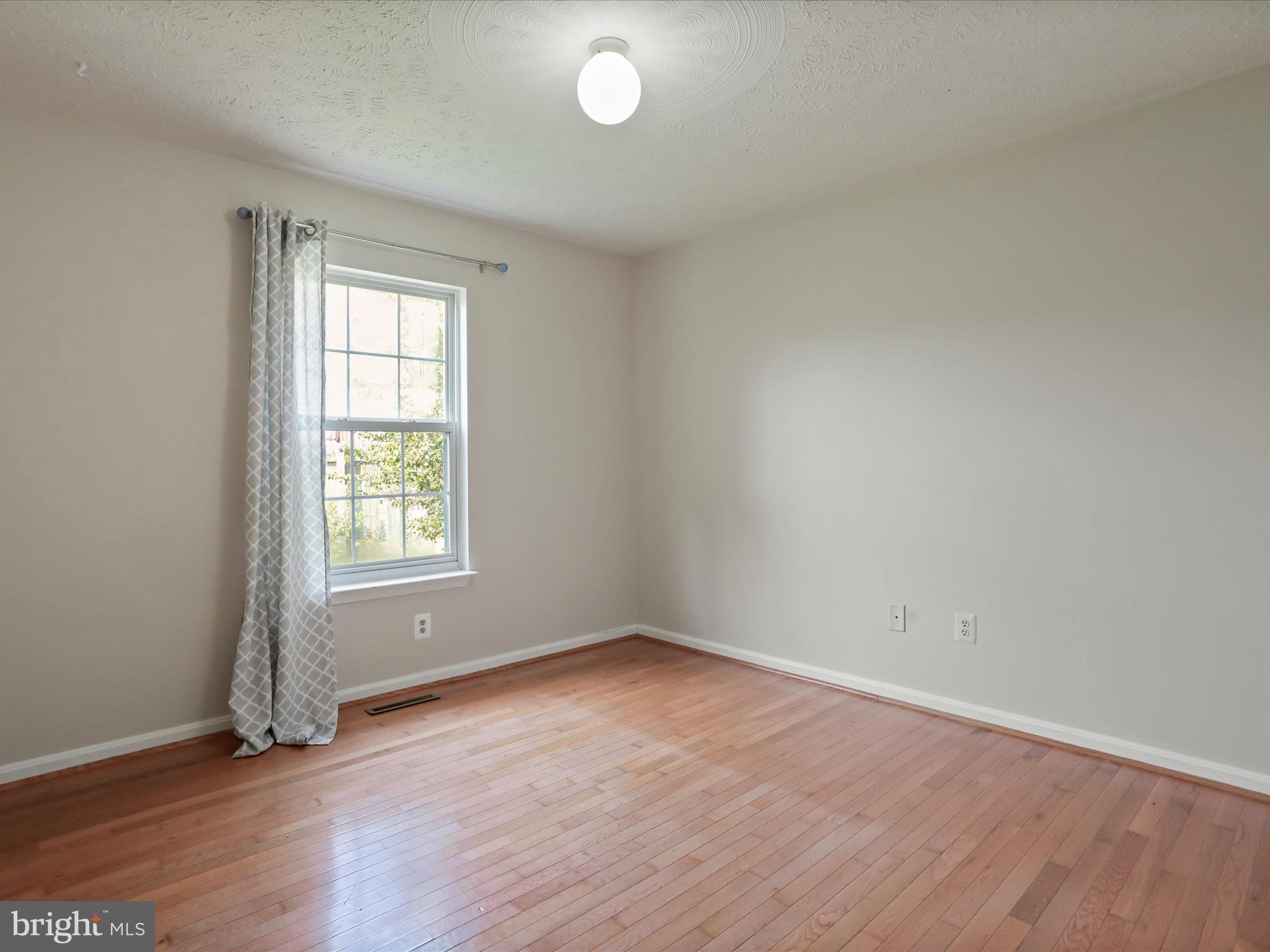 100 Lloyds Road Winchester, VA 22602 - Photo 21 of 39 an empty room with wooden floor and windows