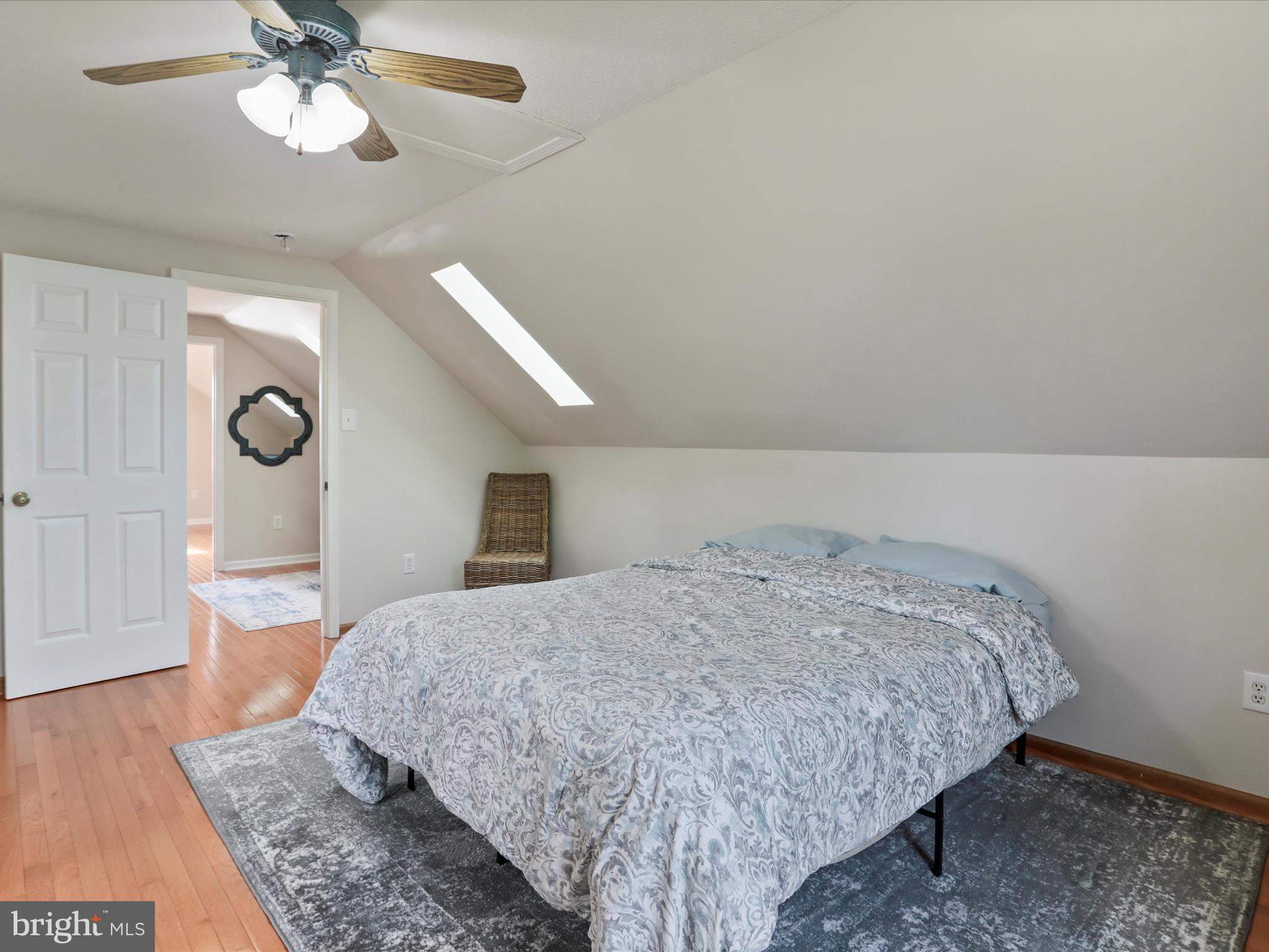 100 Lloyds Road Winchester, VA 22602 - Photo 30 of 39 a spacious bedroom with a bed and a chandelier