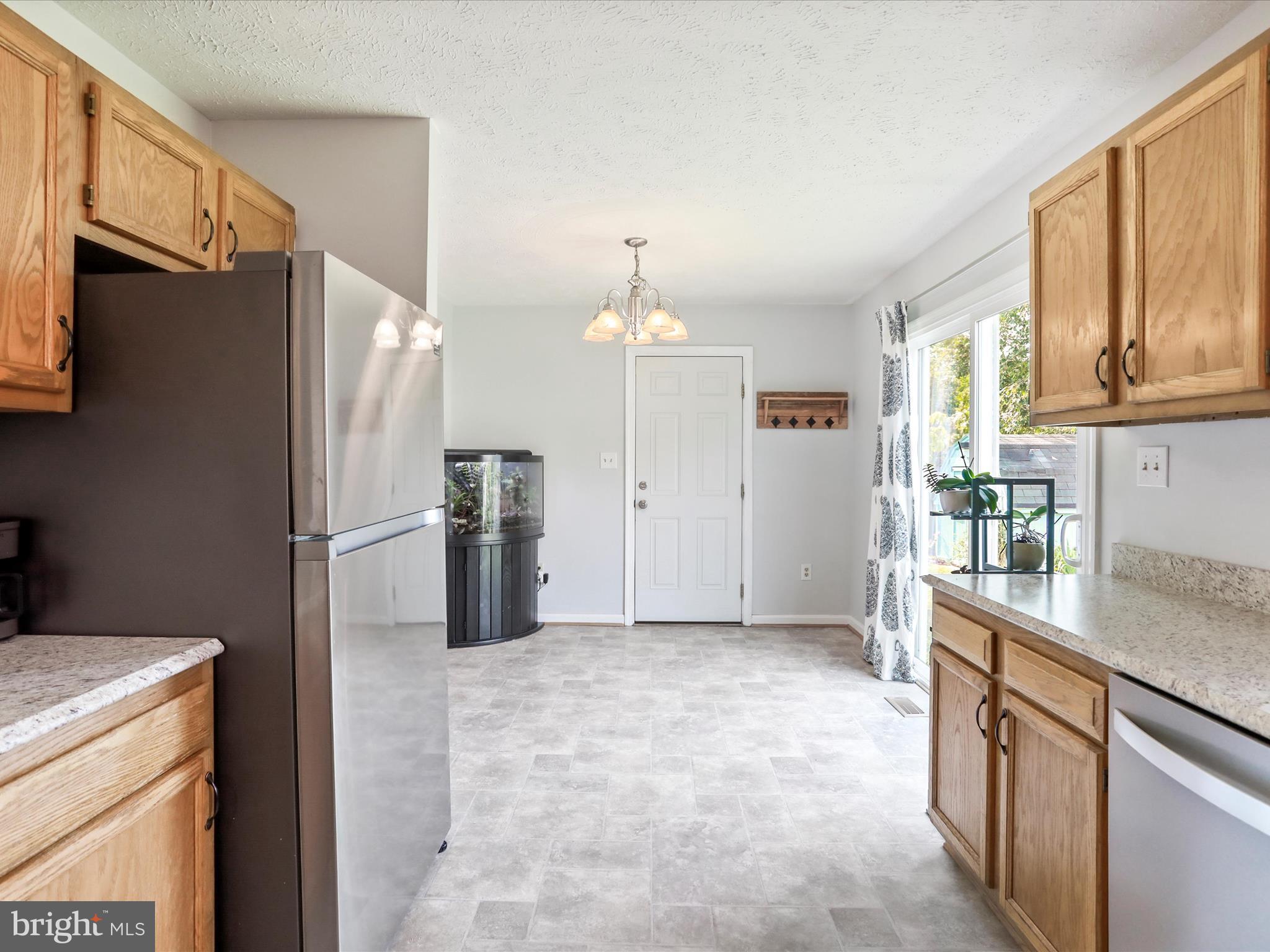 100 Lloyds Road Winchester, VA 22602 - Photo 10 of 39 a kitchen with stainless steel appliances a refrigerator and a stove