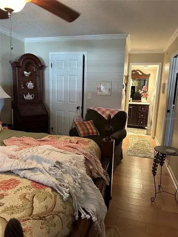 a bedroom with a bed and dresser with mirror
