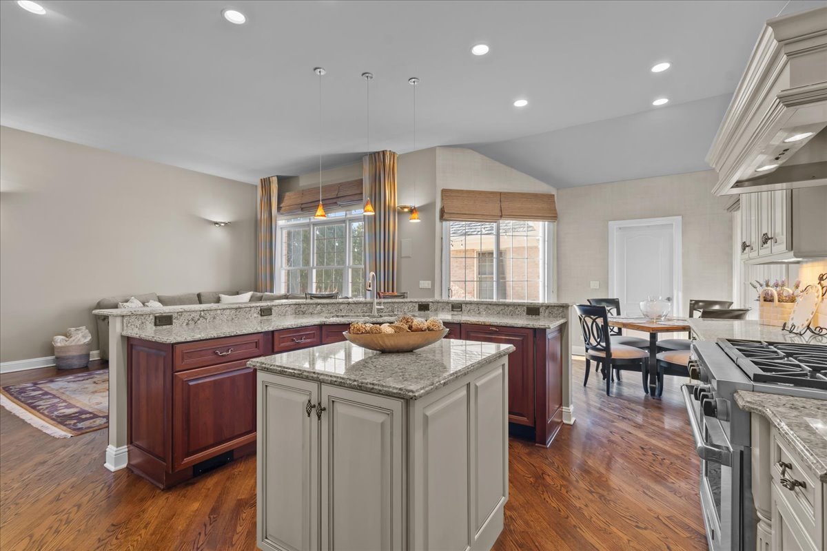 891 Carroll Road Lake Forest, IL 60045 - Photo 14 of 39 a kitchen with kitchen island granite countertop a sink stove and wooden cabinets