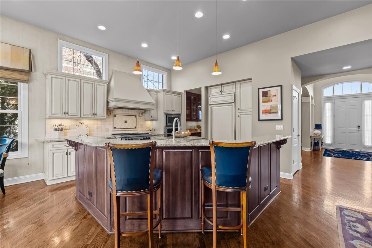 891 Carroll Road Lake Forest, IL 60045 - Photo 10 of 39 a kitchen with stainless steel appliances kitchen island granite countertop wooden cabinets and dining table