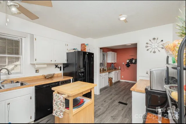 a living room with furniture a flat screen tv and a table
