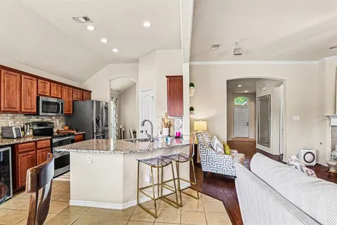 a kitchen with a sink stove and cabinets