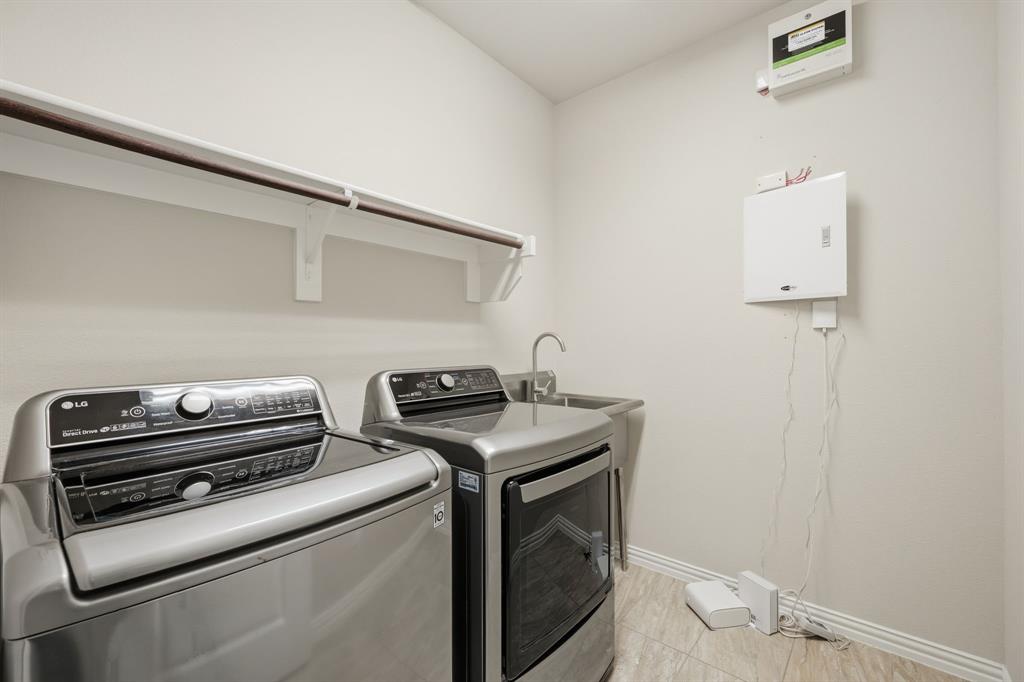 12809 Spring Hill Drive Frisco, TX 75035 - Photo 19 of 37 a utility room with dryer and washer