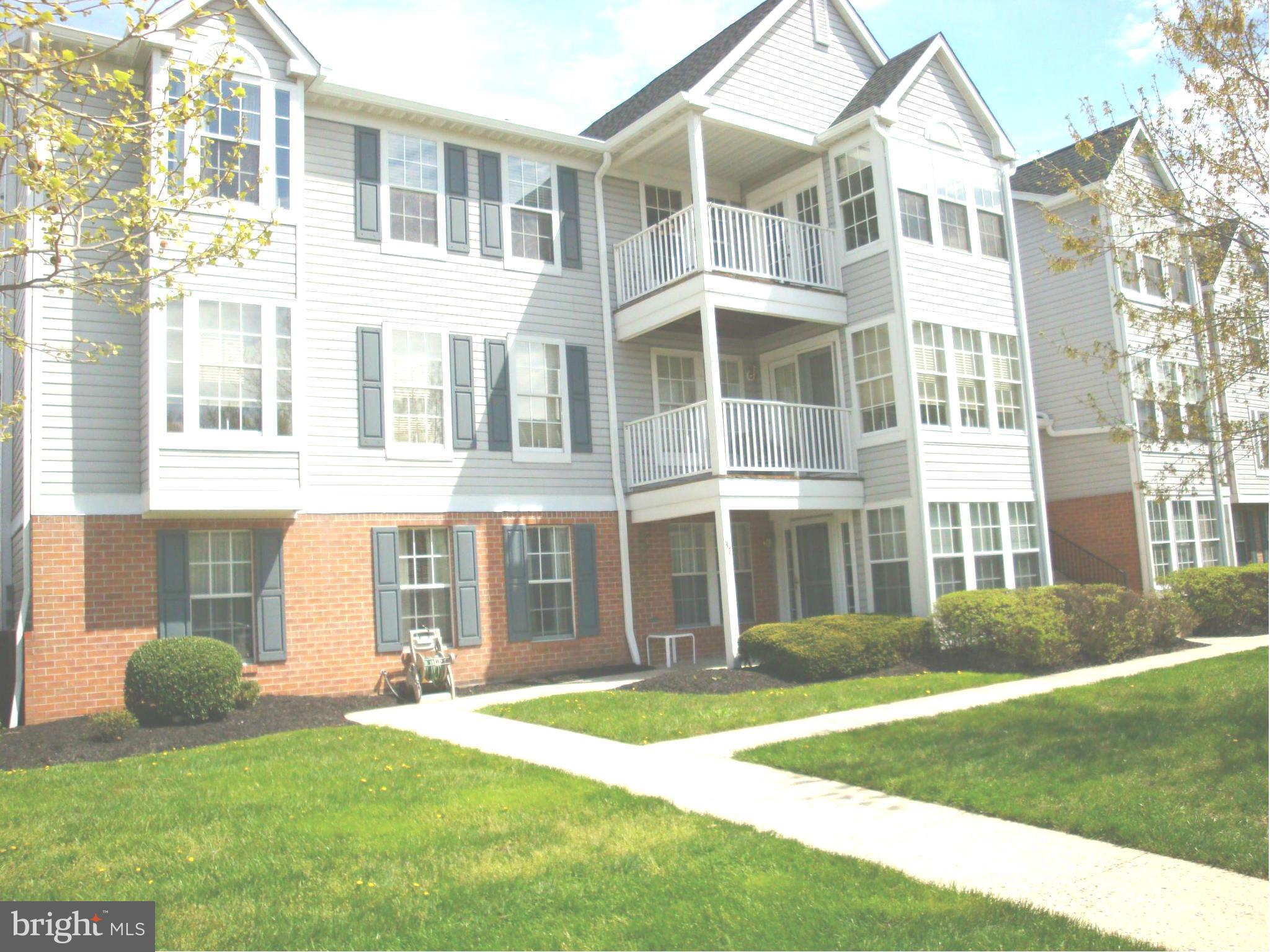 37 Laurel Path Court, Unit 37 Baltimore, MD 21236 - Photo 2 of 22 a front view of a house with a yard and plants