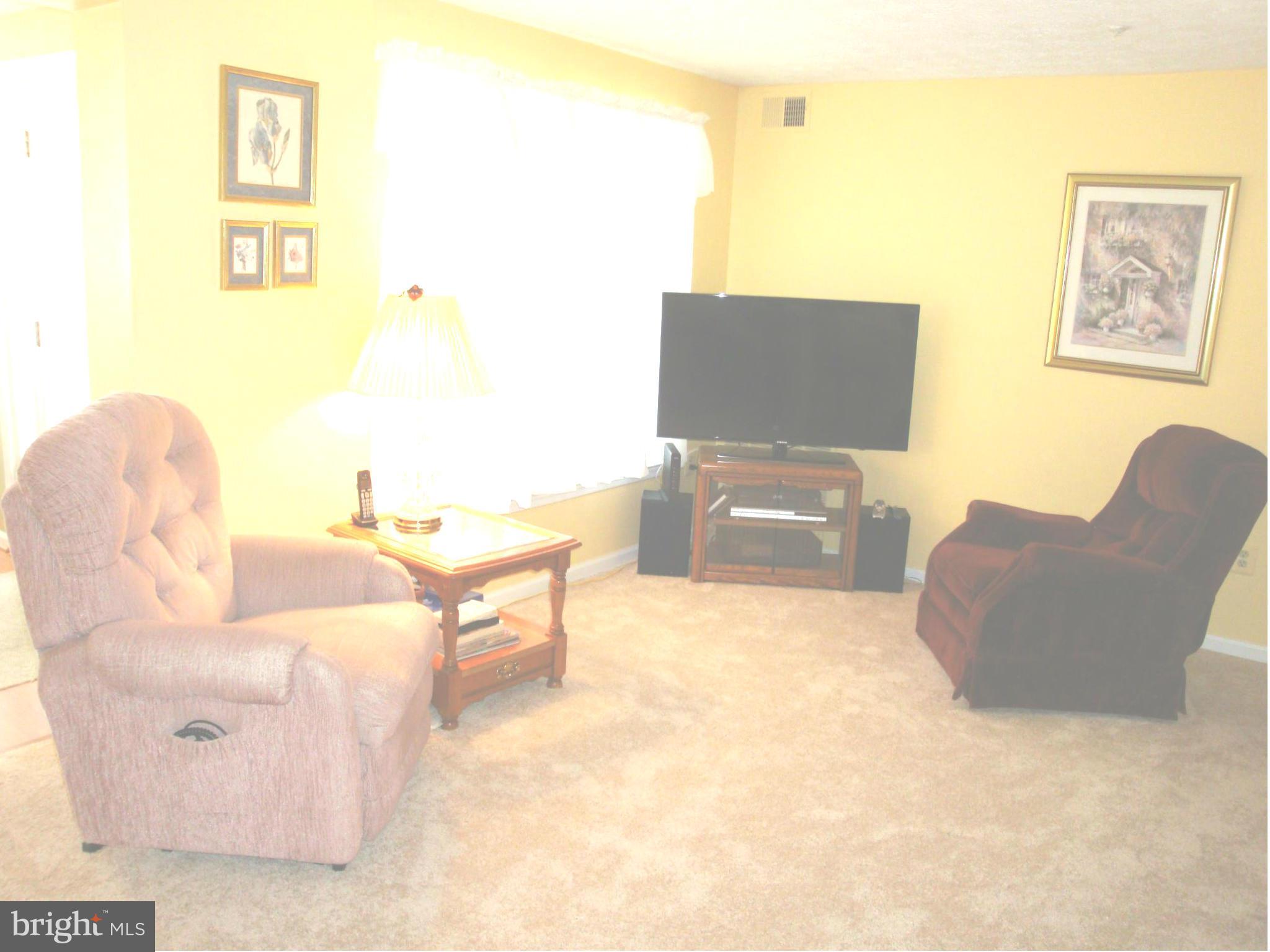 37 Laurel Path Court, Unit 37 Baltimore, MD 21236 - Photo 5 of 22 a living room with furniture and a computer