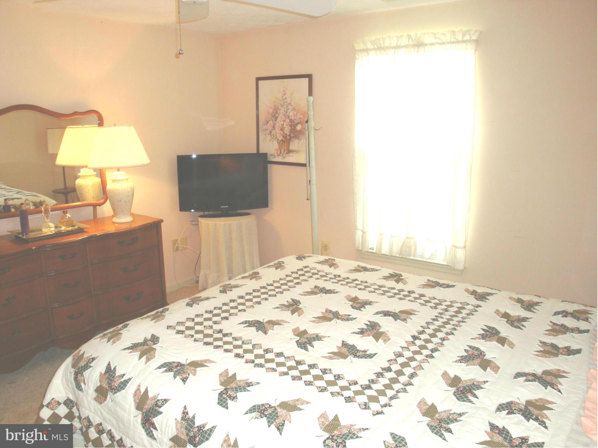 37 Laurel Path Court, Unit 37 Baltimore, MD 21236 - Photo 8 of 22 a bedroom with a bed and a flat screen tv