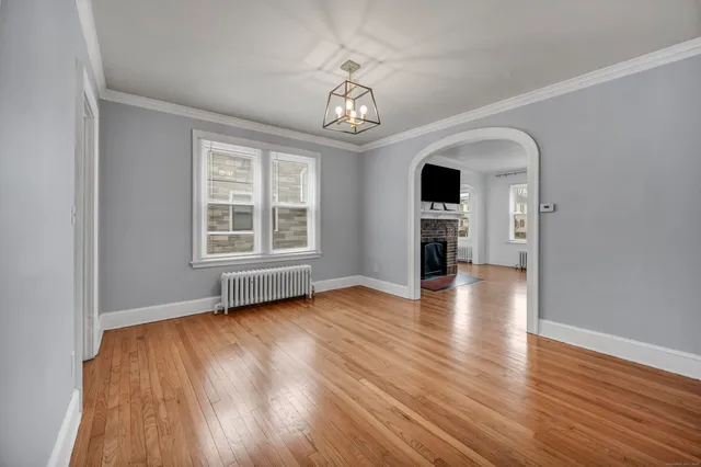 wooden floor in an empty room with a window