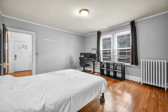 a bedroom with a bed and a large window