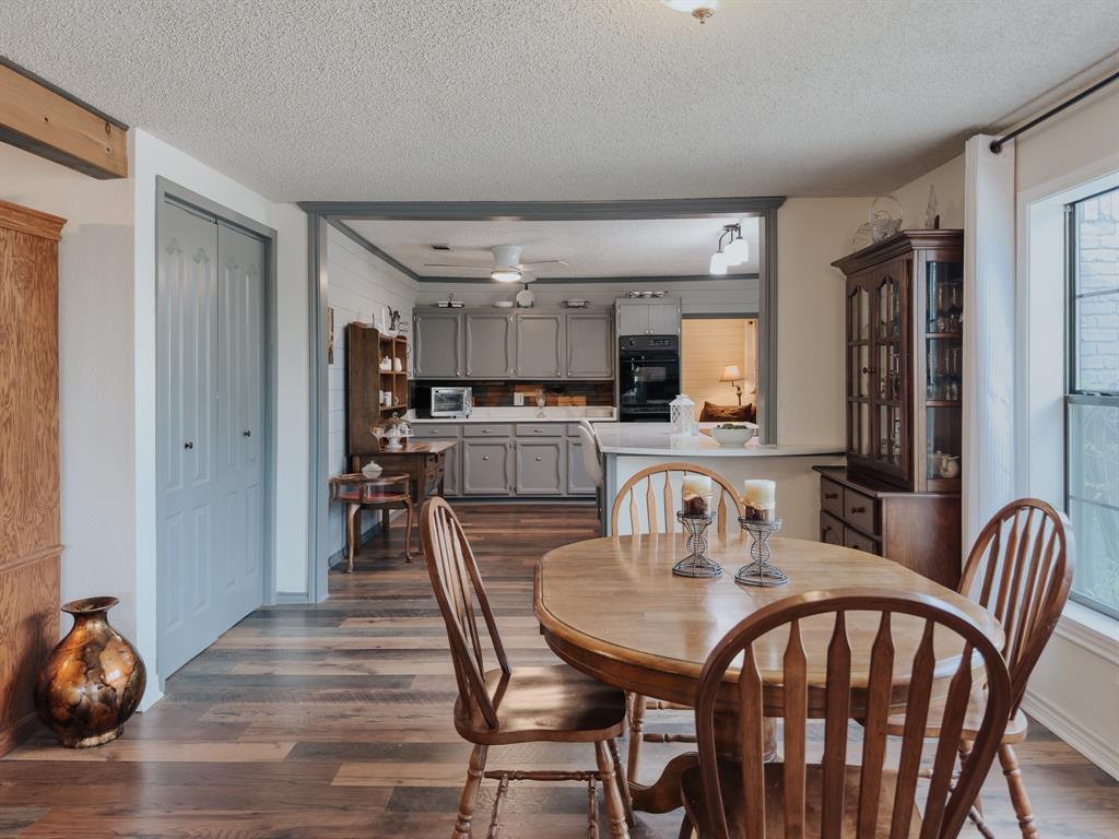 205 Peach Tree Road Mabank, TX 75156 - Photo 13 of 40 a dining room with furniture and wooden floor