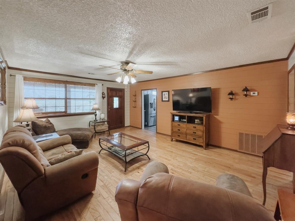 205 Peach Tree Road Mabank, TX 75156 - Photo 23 of 40 a living room with furniture and a flat screen tv