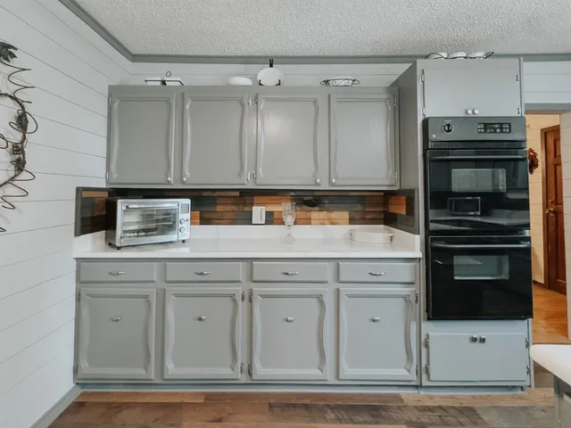 a kitchen with granite countertop a cabinets and stainless steel appliances