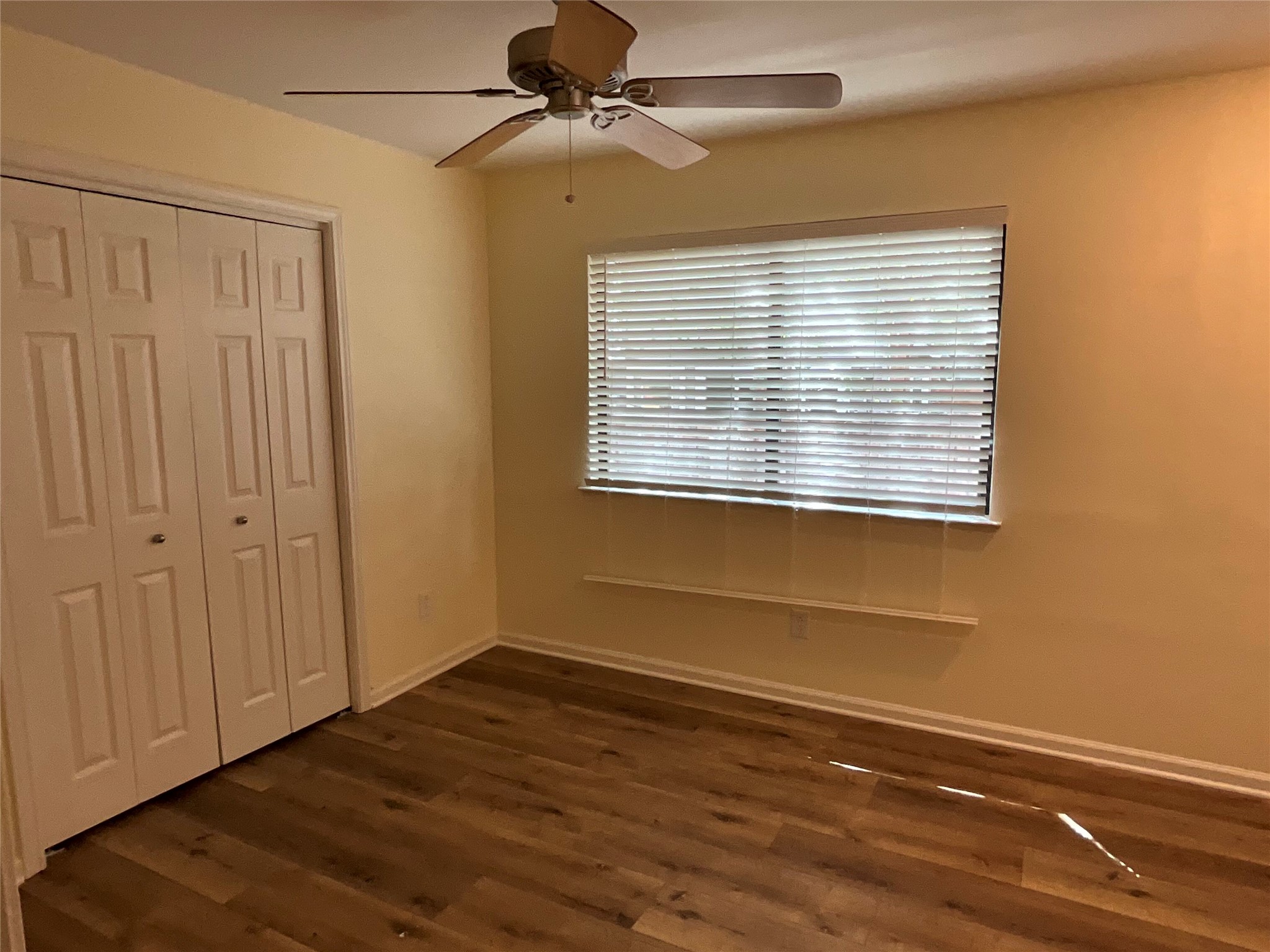 15702 Racine Cove Austin, TX 78717 - Photo 25 of 27 A well-proportioned room showcasing rich wood-tone flooring and a classic ceiling fan.