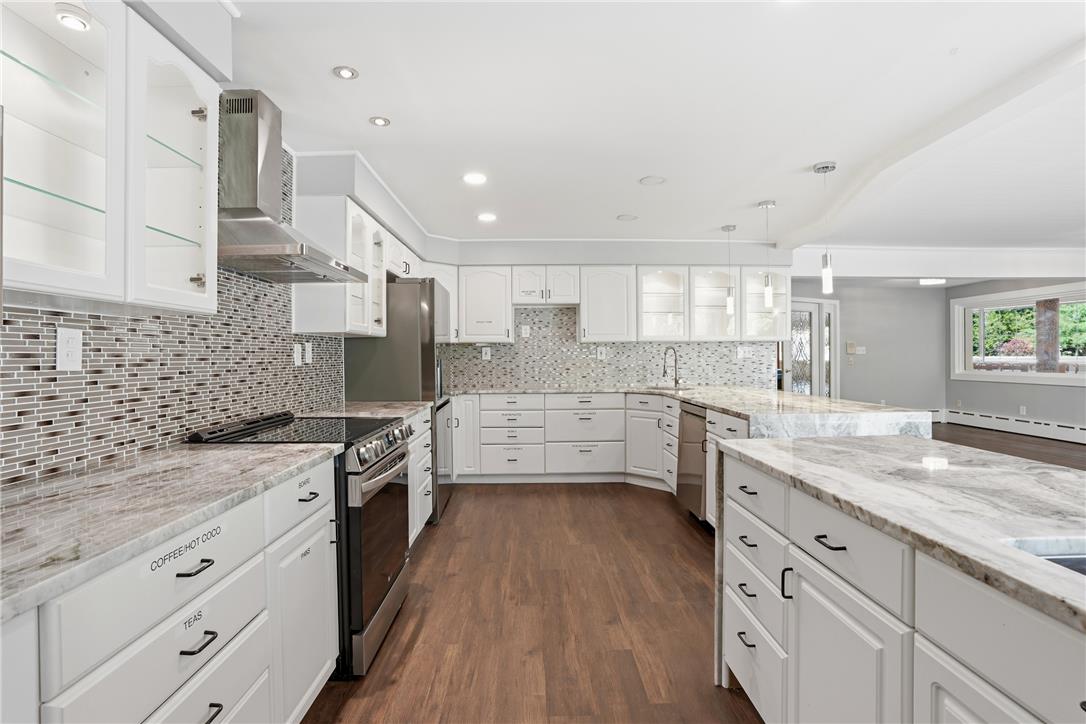 6271 Batman Road Zionsville, PA 18092 - Photo 17 of 100 Discover a spacious culinary haven featuring ample white cabinetry, sleek stainless steel appliances, and gleaming stone countertops.