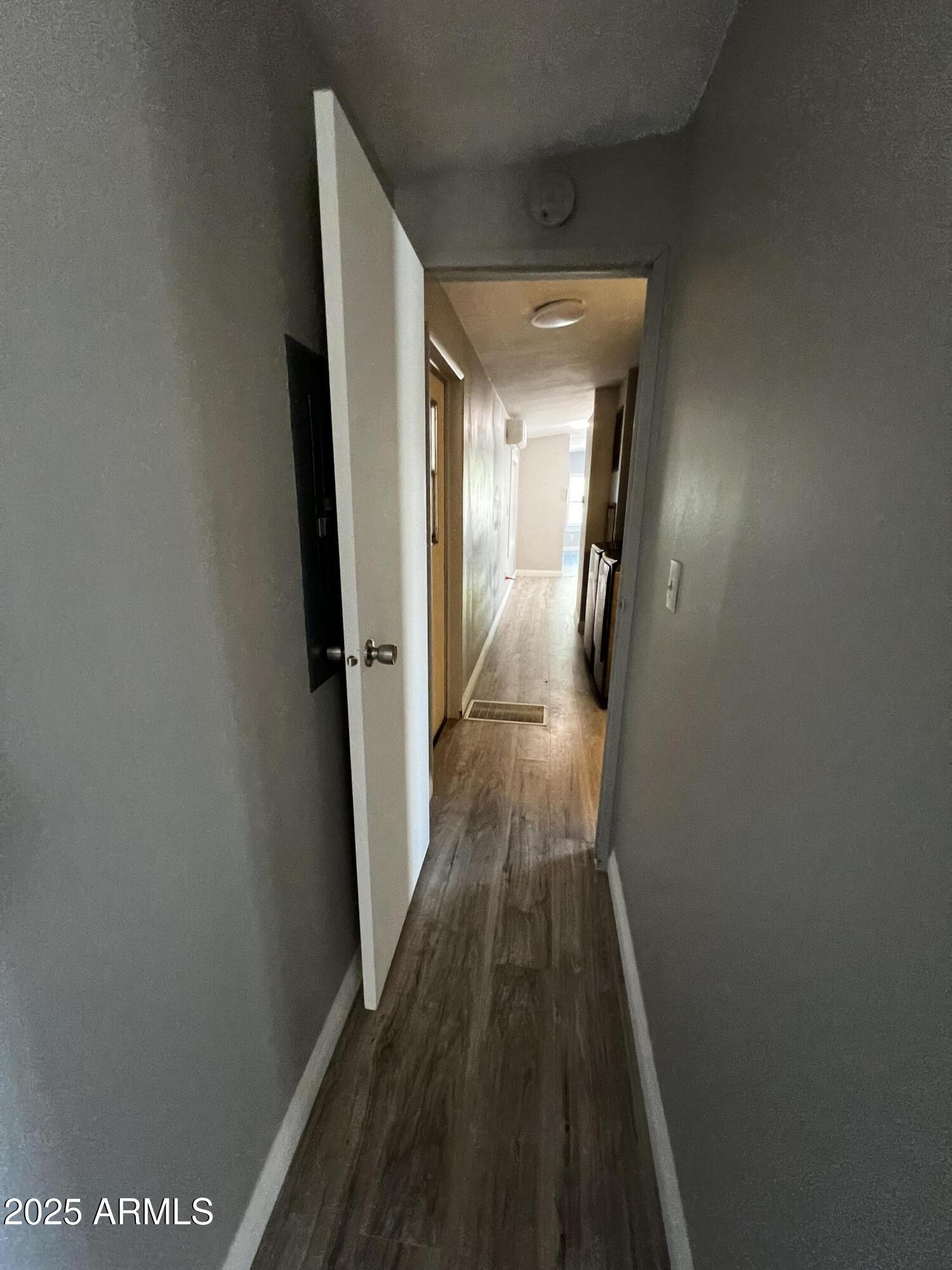 11201 East Jupiter Drive Apache Junction, AZ 85120 - Photo 20 of 35 a view of a hallway with wooden floor and staircase