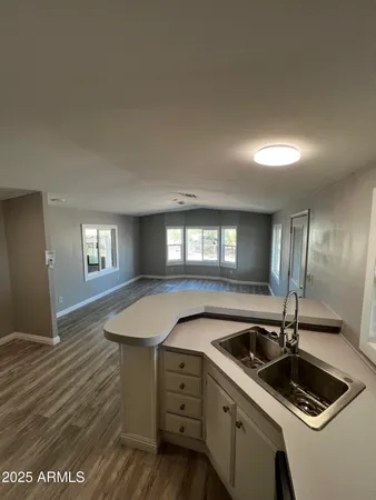 a bathroom with a granite countertop sink toilet and mirror