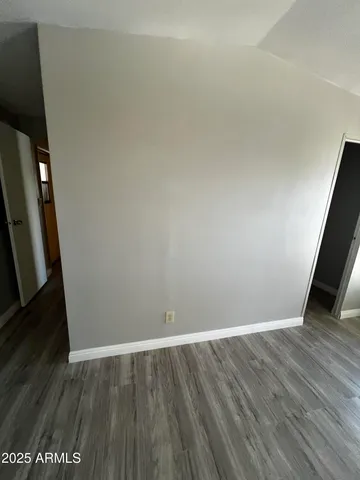 a bathroom with a granite countertop sink toilet and mirror