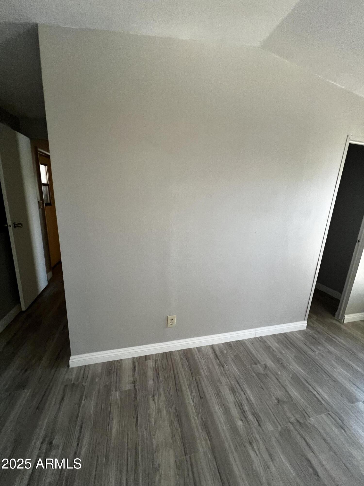 11201 East Jupiter Drive Apache Junction, AZ 85120 - Photo 24 of 35 an empty room with wooden floor and staircase