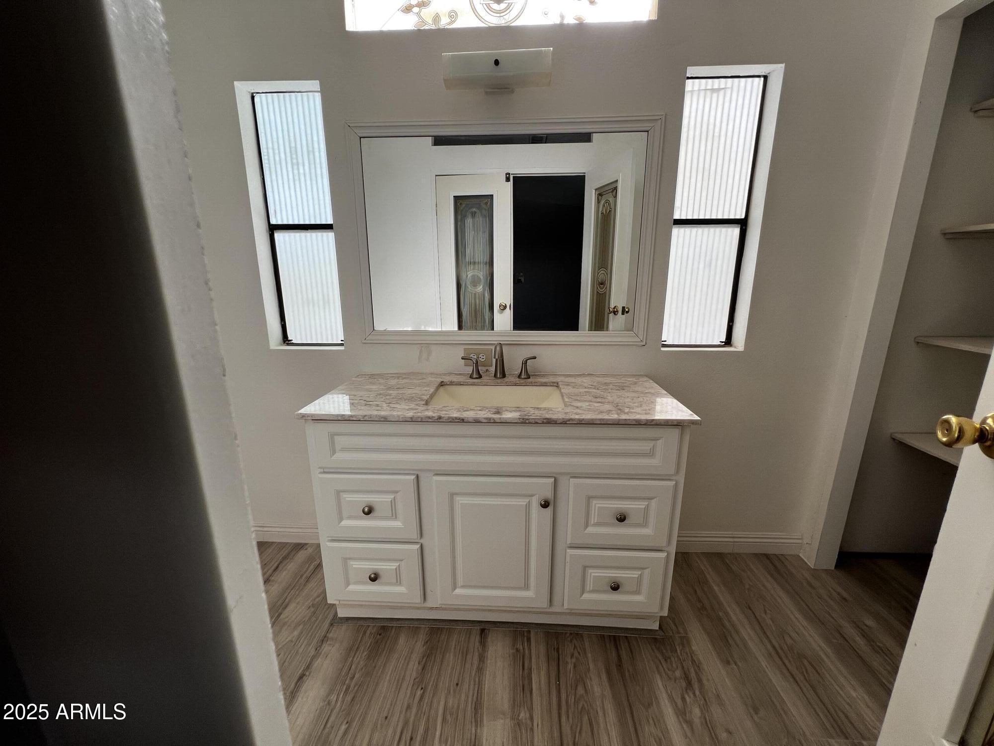 11201 East Jupiter Drive Apache Junction, AZ 85120 - Photo 25 of 35 a bathroom with a granite countertop sink toilet and mirror