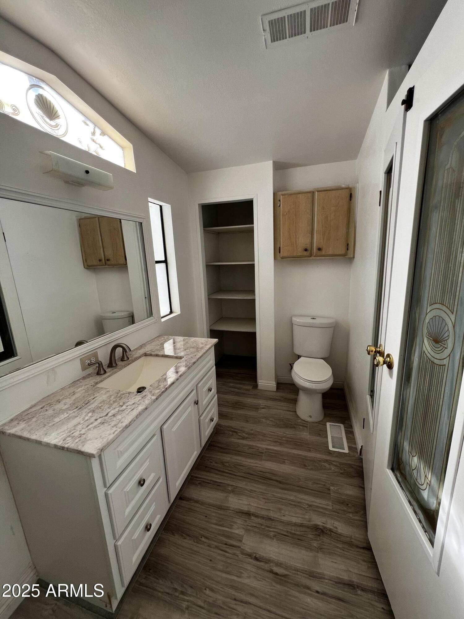 11201 East Jupiter Drive Apache Junction, AZ 85120 - Photo 26 of 35 a bathroom with a sink a toilet and mirror