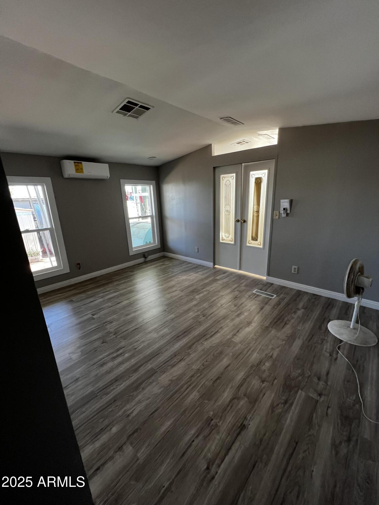 11201 East Jupiter Drive Apache Junction, AZ 85120 - Photo 30 of 35 a view of an empty room with wooden floor and a window