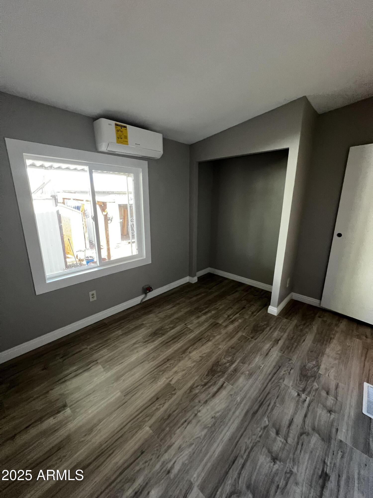 11201 East Jupiter Drive Apache Junction, AZ 85120 - Photo 33 of 35 a view of an empty room with wooden floor and a window