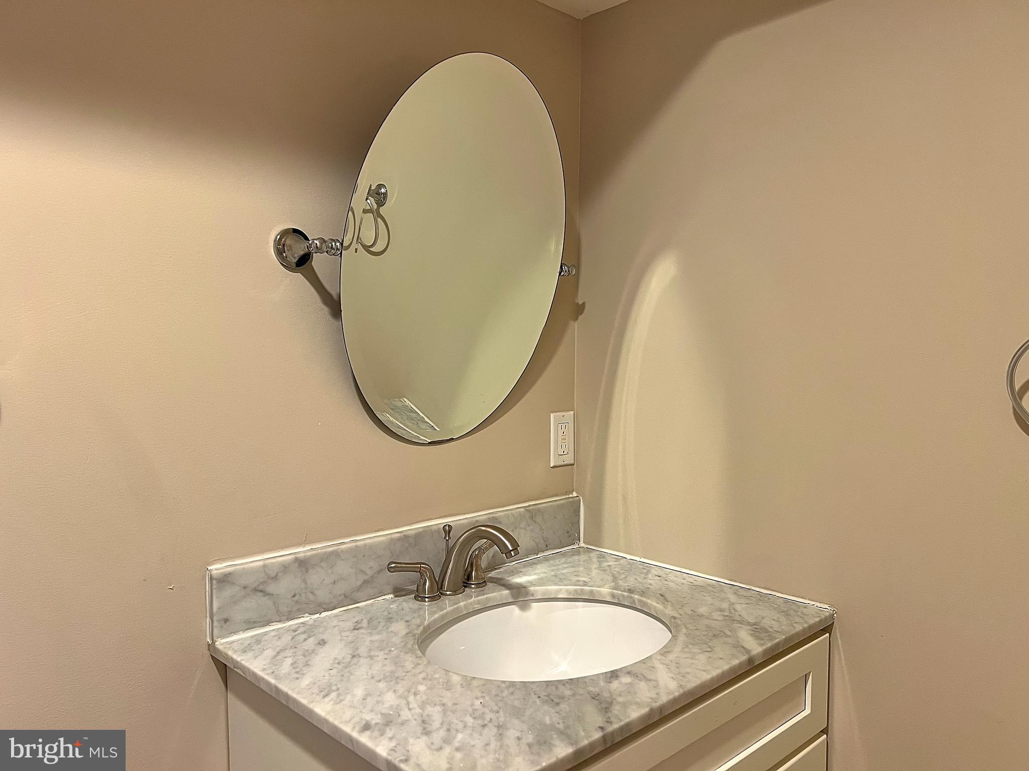 1234 West Cross Street Baltimore, MD 21230 - Photo 15 of 19 a bathroom with a granite countertop sink a mirror and a